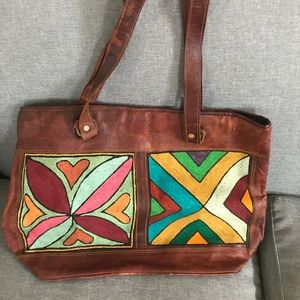 Embroidered leather messenger bag